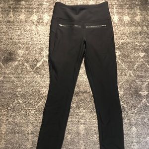 Black athleta legging with zippers in front